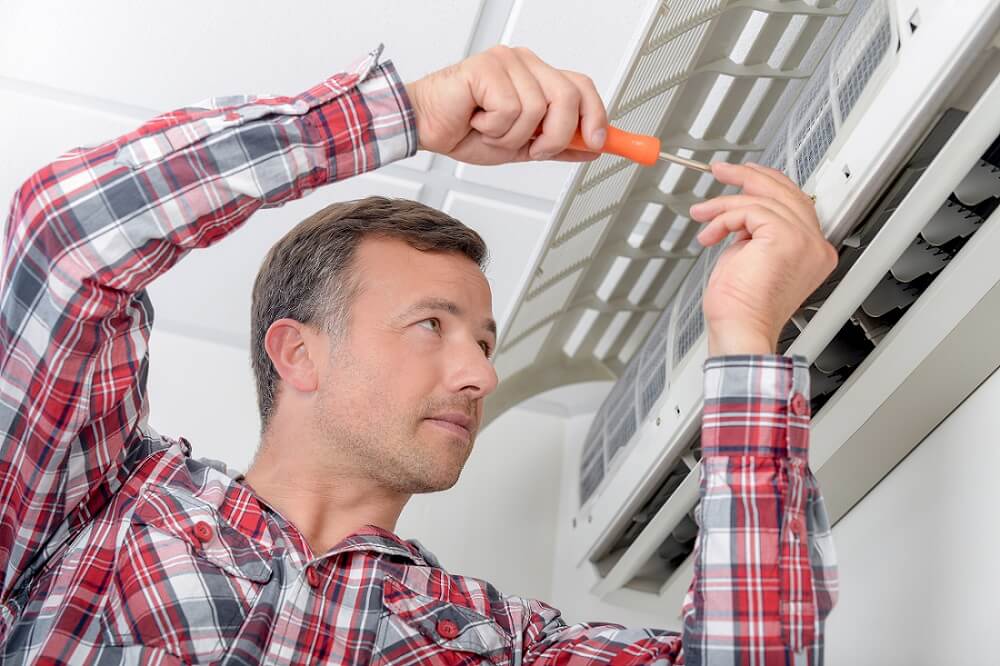 How can you troubleshoot a frozen coil in your air conditioner?