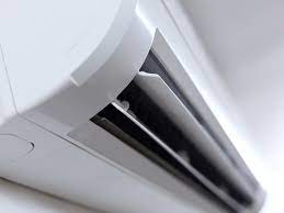 What are some common signs that the condensate drain line is clogged in an air conditioner?